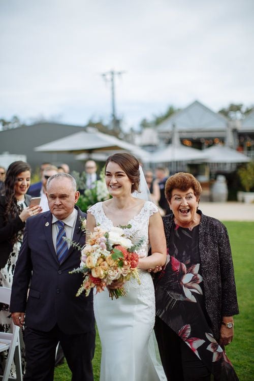 Father giving the bride away beneath the willows