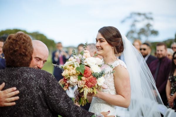 A ceremony moment beneath the willows at Crittenden Estate