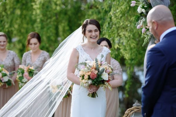 The couple during their vows by the Crittenden Estate lake