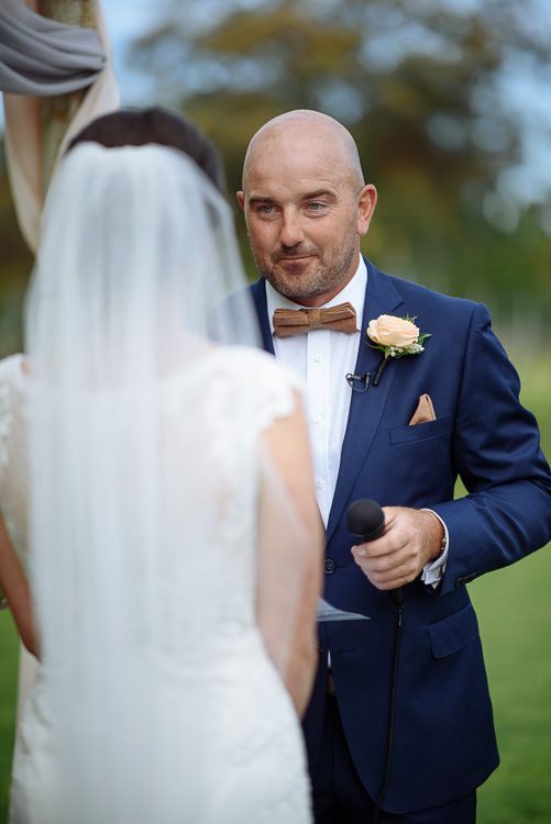 Wedding ceremony beneath the willows beside the Crittenden Estate lake