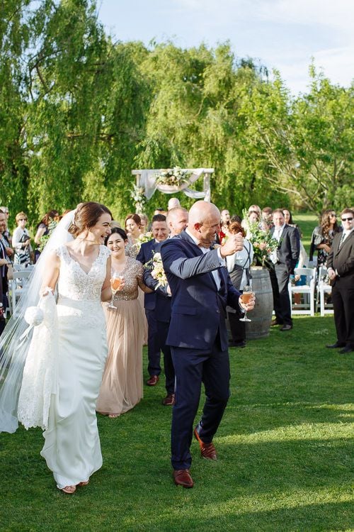 Wedding ceremony beneath the willows beside the Crittenden Estate lake