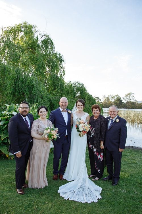 Candid congratulations after the lakeside ceremony