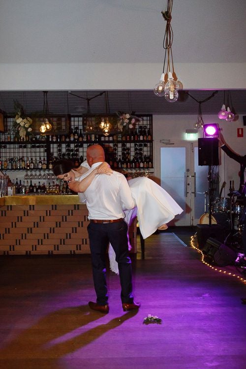 Groom dipping the bride on the dancefloor