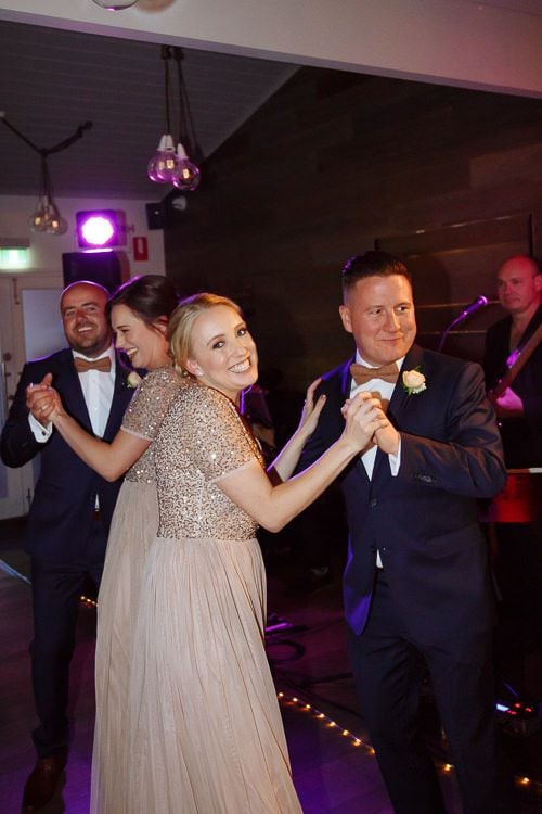 Groomsmen and bridesmaids dancing at the reception