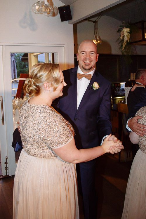Bridesmaid and groomsman dancing together at the reception