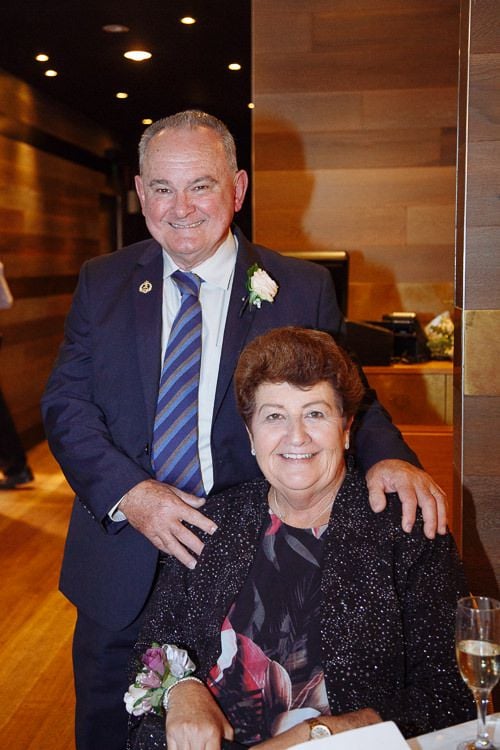 Grandparents smiling for a portrait at the reception