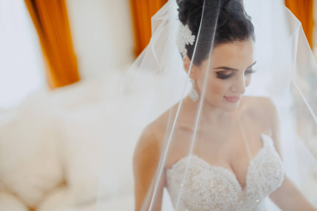 Danielle looks down beneath her veil in a close bridal portrait