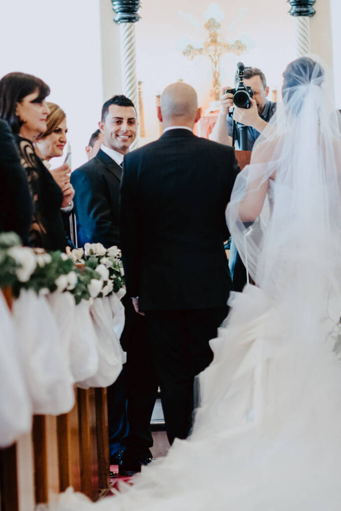 Michael welcomes Danielle and her escort at the front of St Aphrem
