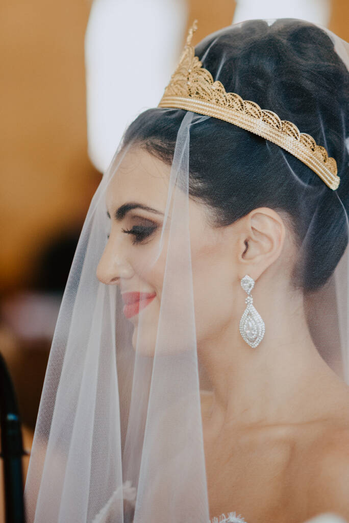 Danielle wears a gold wedding crown over her veil during the Syrian Orthodox ceremony