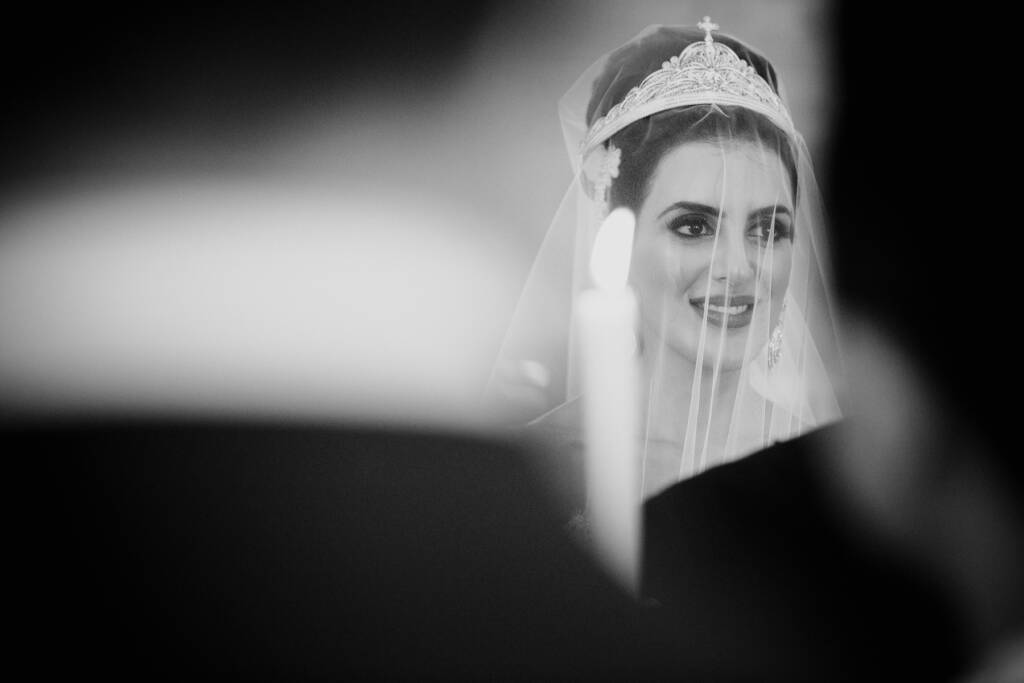 Black-and-white photo of Danielle smiling beneath her veil and wedding crown