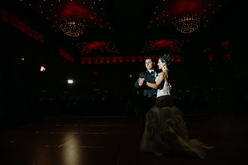 Danielle and Michael share their first dance beneath chandeliers at their Palladium at Crown ballroom wedding