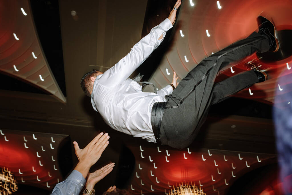 Guests toss Michael into the air beneath the ceiling at Crown Palladium