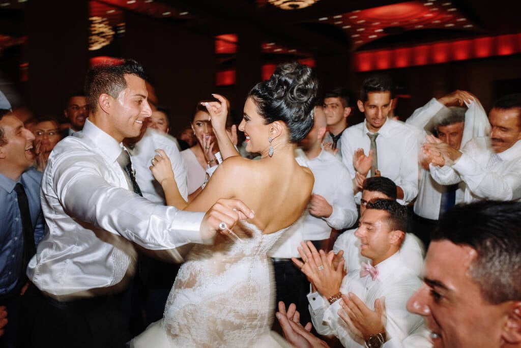Danielle and Michael dance surrounded by clapping guests during their Lebanese wedding reception
