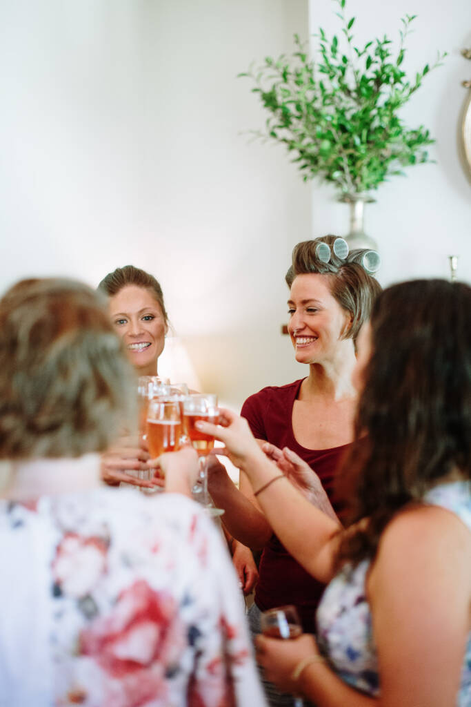 Camilla and guests raise glasses together during bridal preparation at Flowerdale.