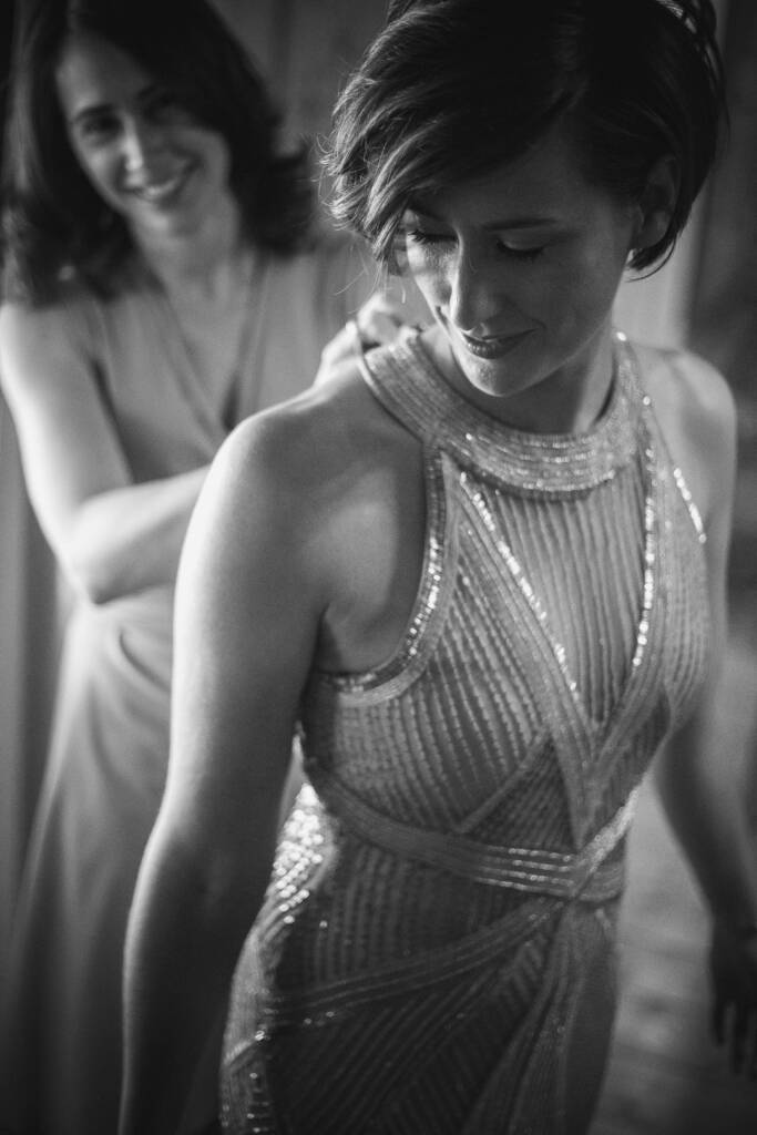 A companion helps Camilla with the back of her beaded gown at Flowerdale Estate.
