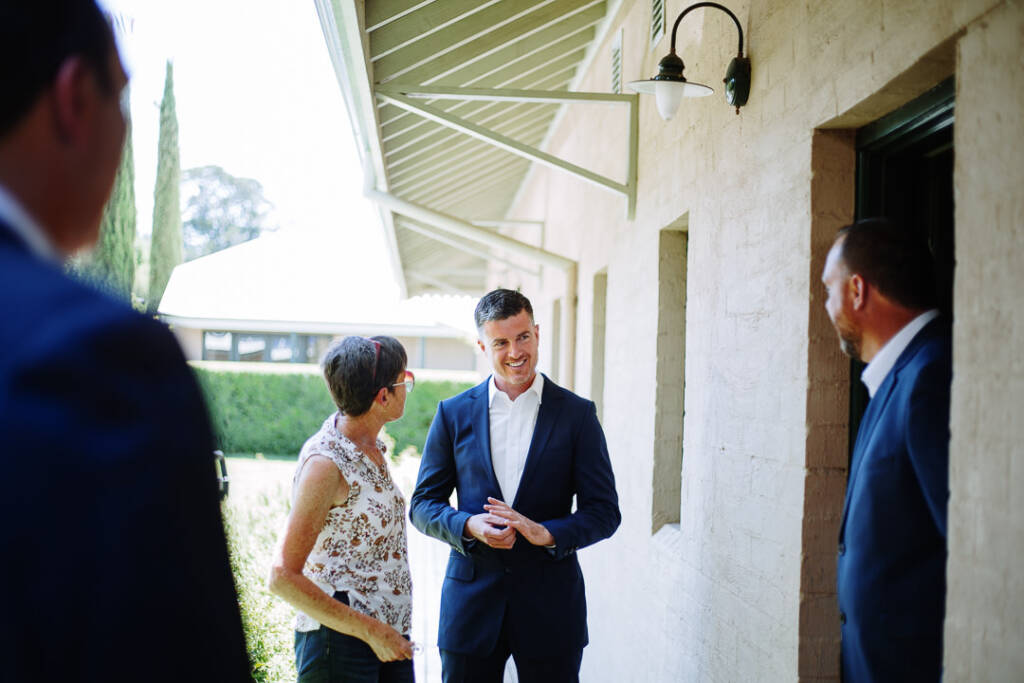 Jason smiles during a conversation beneath a verandah roof at Flowerdale Estate.