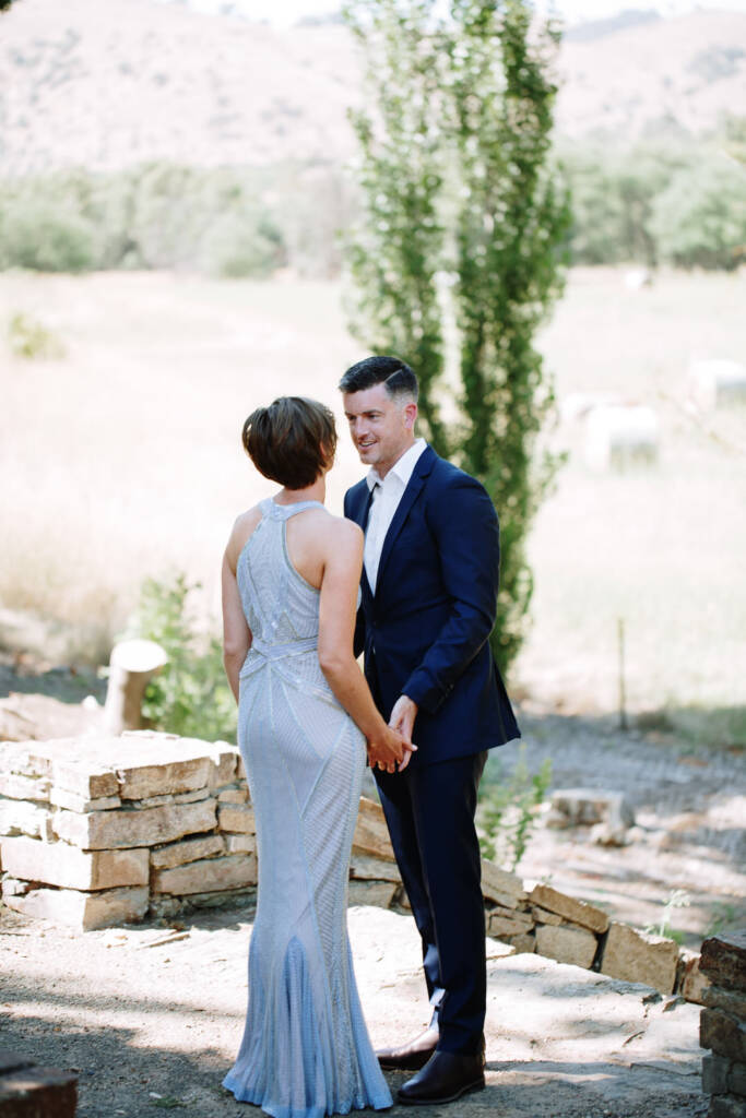 Camilla and Jason face each other holding hands after their first look at Flowerdale.