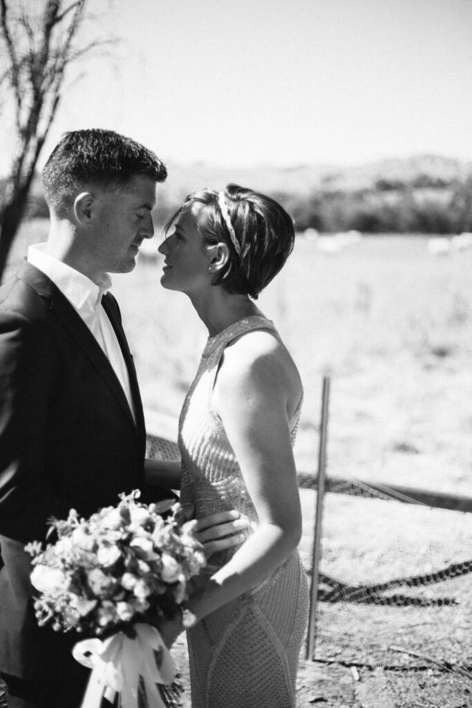 Black-and-white close portrait of Camilla and Jason facing each other.