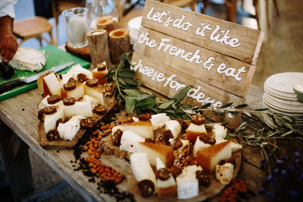 Cheese boards and accompaniments beneath a cheese-for-dessert sign at Flowerdale.