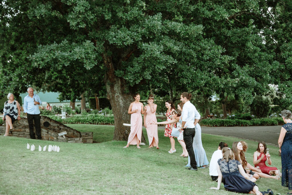 Camilla throws a piece towards lawn skittles as guests watch at Flowerdale.