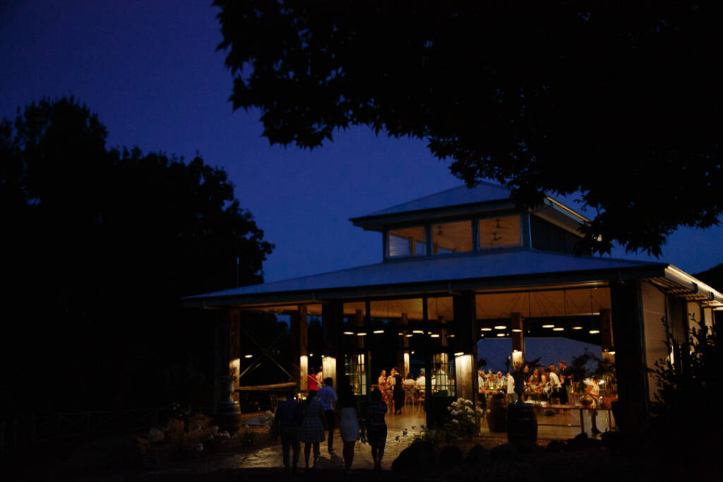 The Flowerdale Estate reception pavilion glows under a deep blue evening sky.