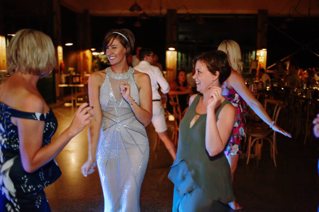 Camilla dances with guests beneath the Flowerdale Estate pavilion lights.