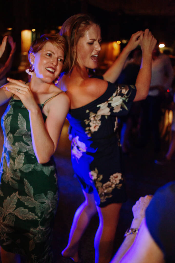 Two guests dance under coloured lighting at the Flowerdale reception.