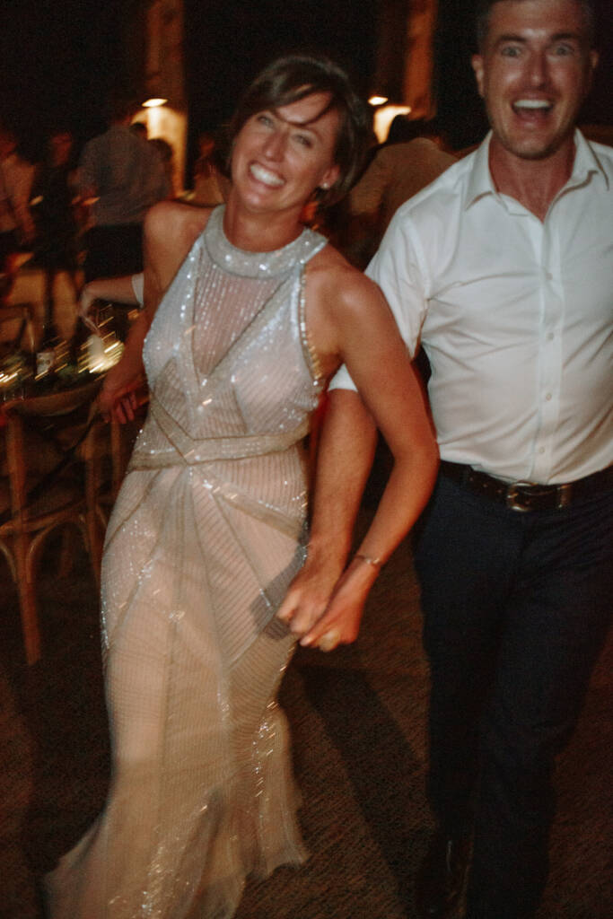 Camilla and Jason smile on the dance floor beneath the Flowerdale Estate pavilion lights.