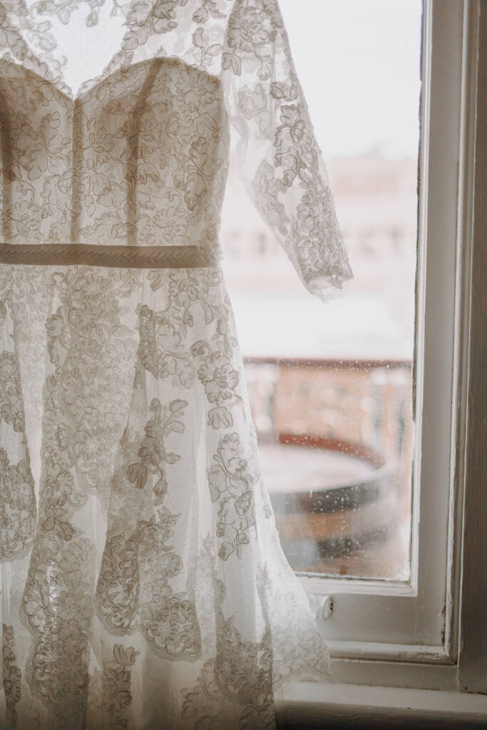Bethany’s lace wedding gown hangs in a sash window at the Royal Hotel.