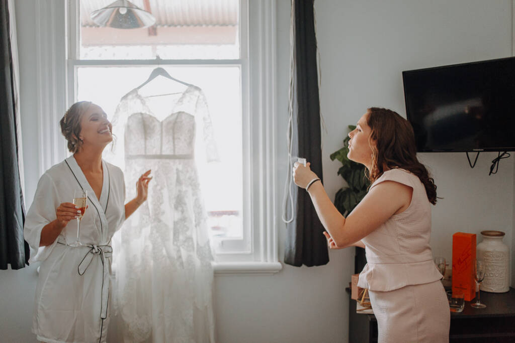 Bethany laughs with a guest during bridal preparation at Royal Hotel Sea Lake.