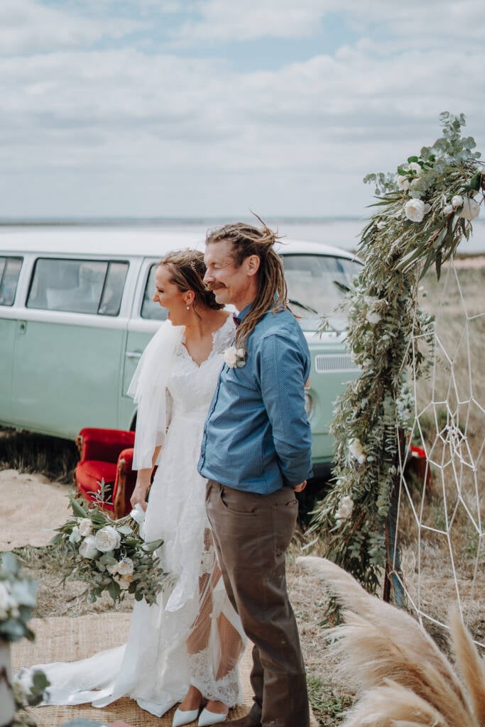 Bethany and Dale laugh beside the foliage arbour and mint van at Pink Lake Reserve, Lake Tyrrell.