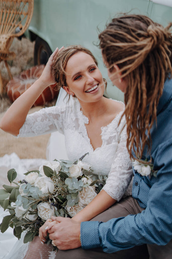 Bethany touches her hair while seated beside Dale at Pink Lake Reserve, Lake Tyrrell.
