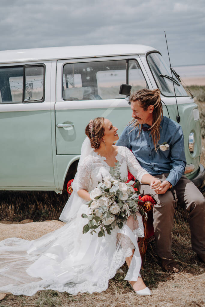 Bethany and Dale hold hands on a red armchair beside the mint-and-white van at Lake Tyrrell.