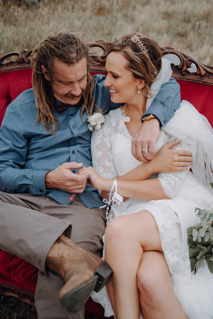 Dale touches Bethany’s ring hand as they sit together at Pink Lake Reserve, Lake Tyrrell.