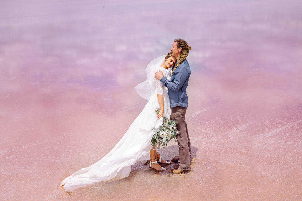 Dale embraces Bethany as she rests her head against him on Lake Tyrrell’s pink-toned surface.