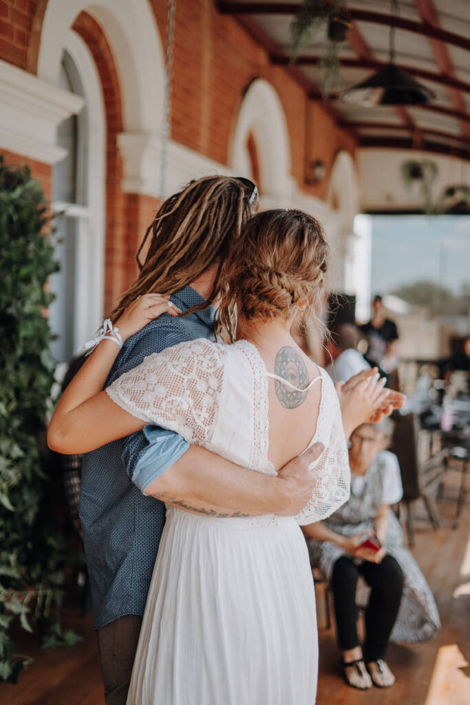 Bethany and Dale dance beside brick arches at Royal Hotel Sea Lake.