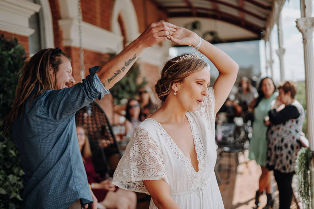 Dale twirls Bethany beneath his raised arm on the Royal Hotel’s verandah.