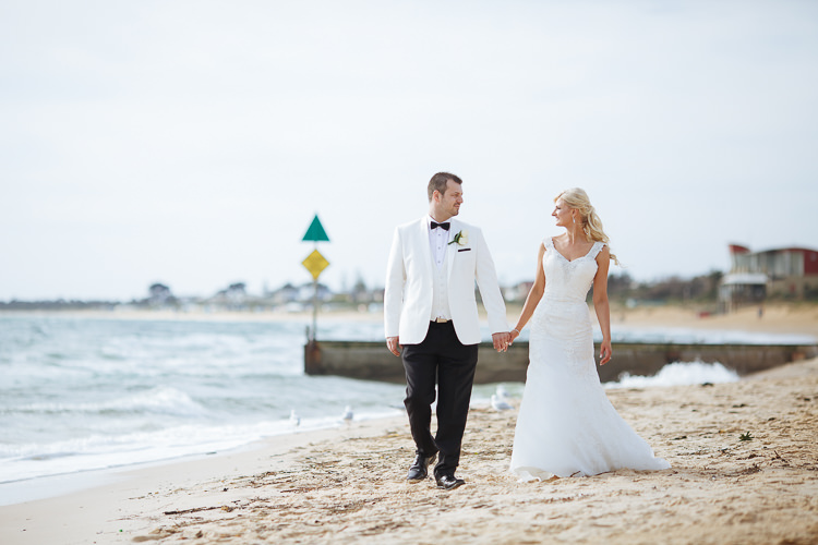 Aggie and Alex hold hands at Frankston Beach on the Mornington Peninsula.