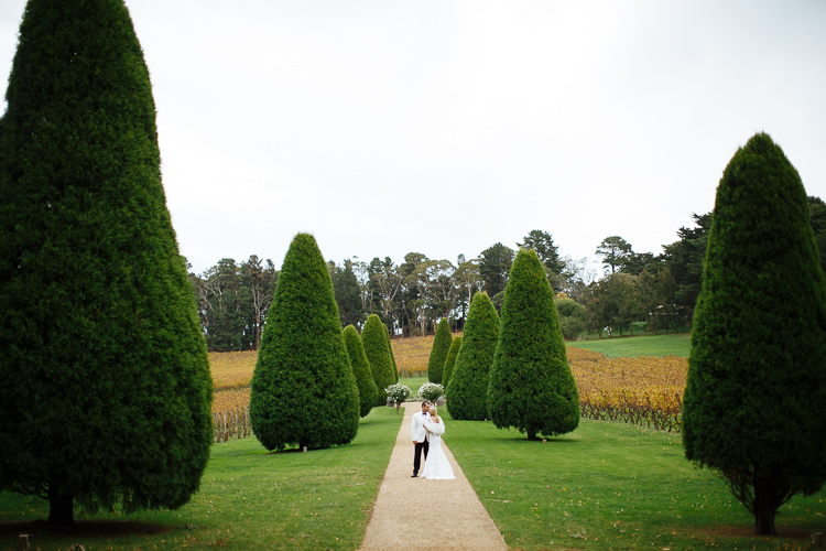 Aggie and Alex pose on a topiary-lined path at Lindenderry Red Hill on the Mornington Peninsula.