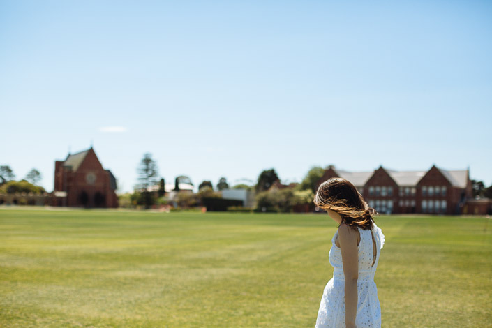 Wind lifts the woman's hair on the oval at Geelong Grammar School in Corio.
