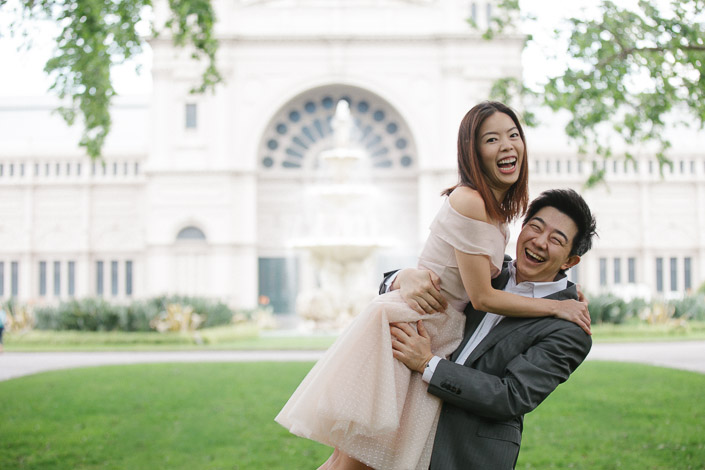 Laughter mid spin before the fountain arch, tulle skirt swinging in the man's arms.