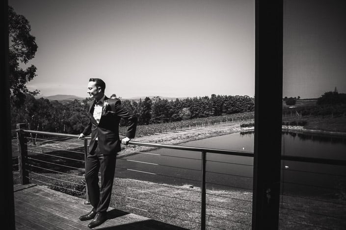 The groom pauses on a deck at Ainsworth Estate in Seville.