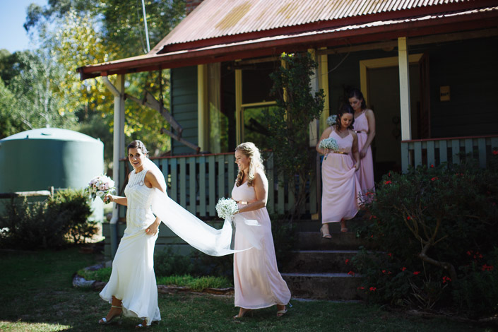 The bride leads her bridesmaids from Merrigum Cottage in Seville.