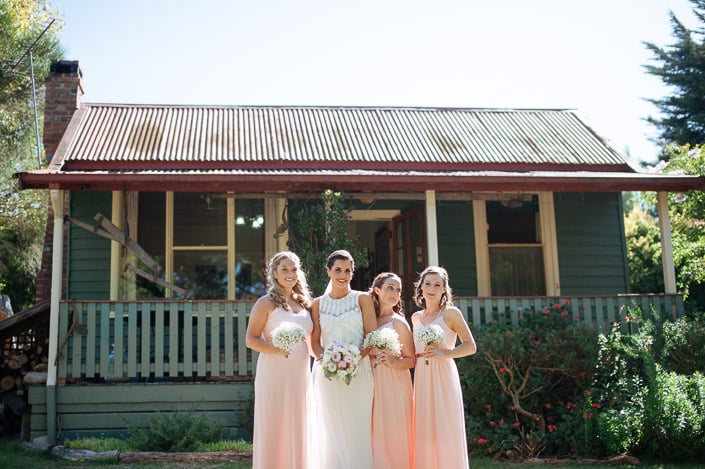 The bride and three bridesmaids pose in the garden at Merrigum Cottage in Seville.