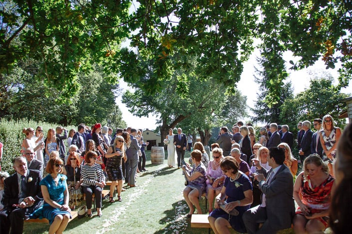 The bride enters the tree-shaded ceremony aisle at Paynes Rise in the Yarra Valley.