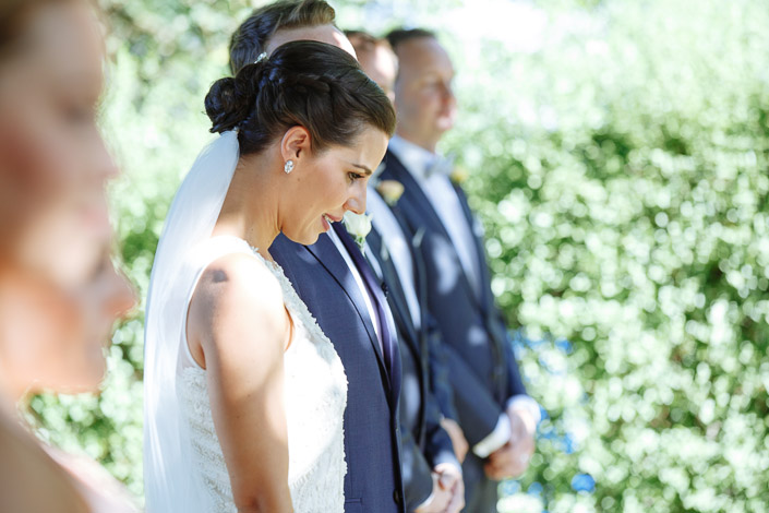 The bride looks down during the outdoor ceremony at Payne’s Rise Vineyard.
