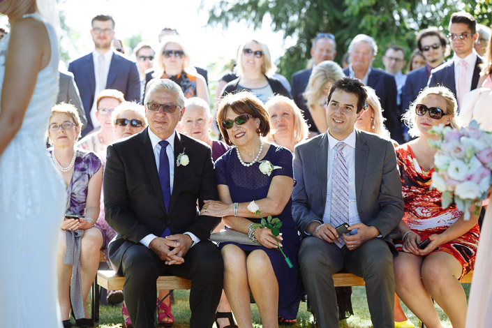 Guests watch from a timber bench during the ceremony at Paynes Rise.