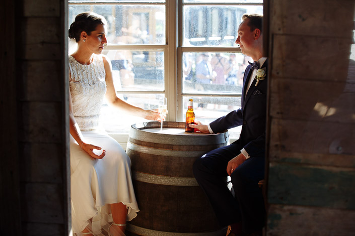 The couple share a drink by a wine barrel at Payne’s Rise Vineyard.