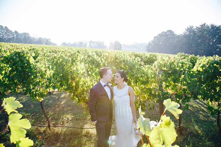 An almost-kiss between the leafy rows in the afternoon glow