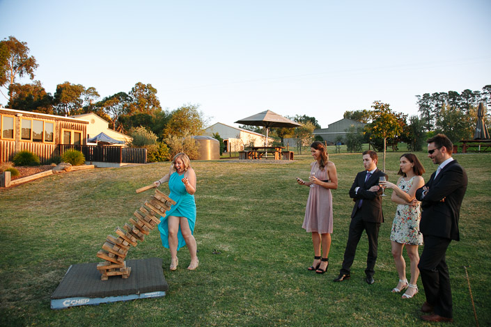 A guest pulls a block from a timber tower on the lawn at Payne’s Rise Vineyard.